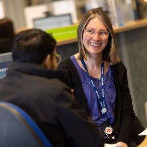 Member of student services advising a student.