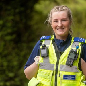 Former Derby College student Holly, a young lady with blonde hair wearing a hi-viz police gilet and uniform.