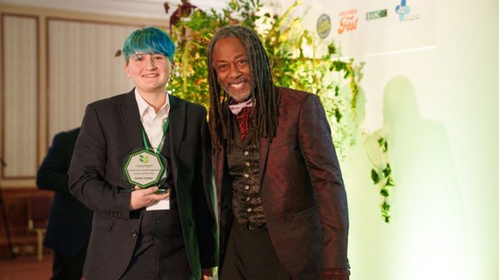 Young student being handed an award.