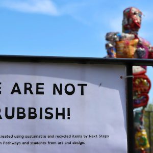 Sculpture made from rubbish with a plaque reading 'We Are Not Rubbish'